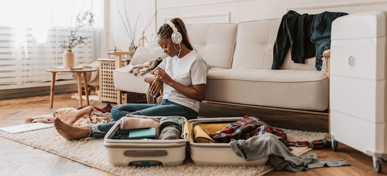 Woman packing a suitcase after learning how to prepare for rehab.
