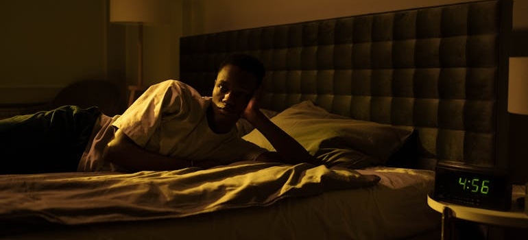 Man with insomnia lying on the bed.