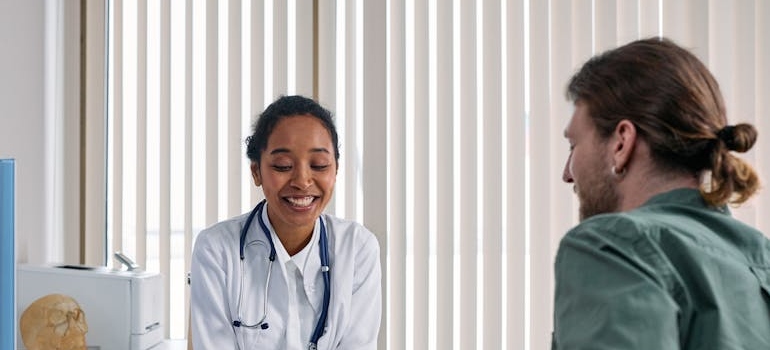 Doctor smiling while talking with her patient.