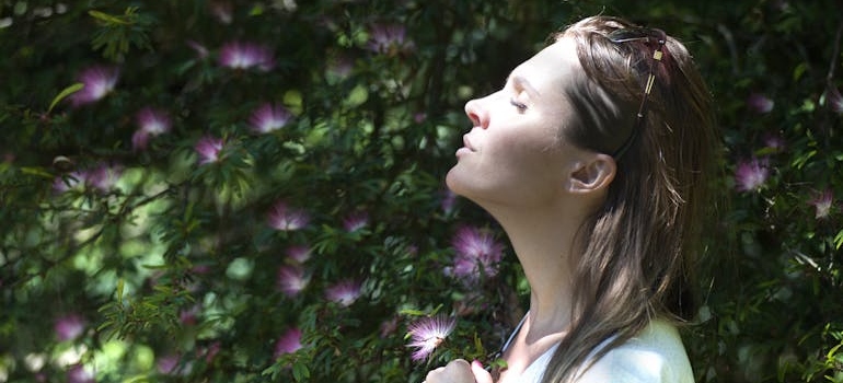 Woman doing breathing exercises to ground herself.