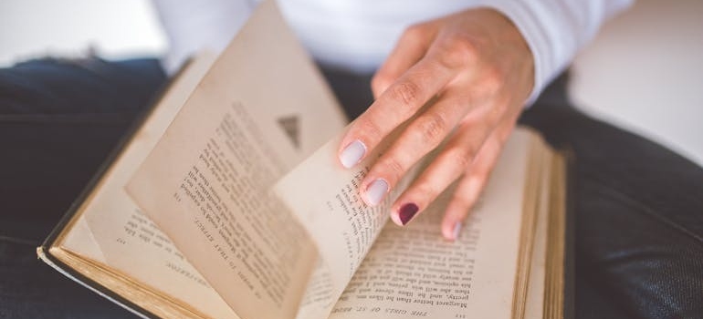 Person turning a page on a book.