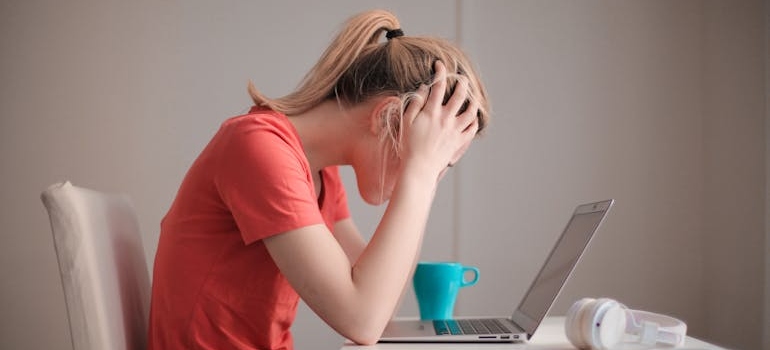 Stressed out woman looking at her laptop.