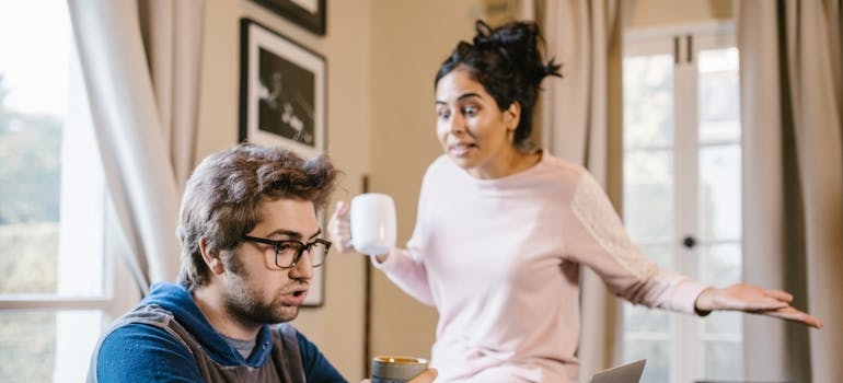 Man thinking about how to leave a toxic relationship while his wife yells at him.