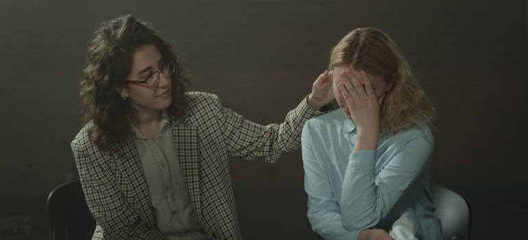 Therapist comforting her patient while discussing what is high intensity drinking.