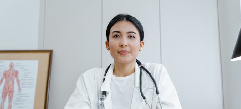 Doctor smiling and sitting at her desk.