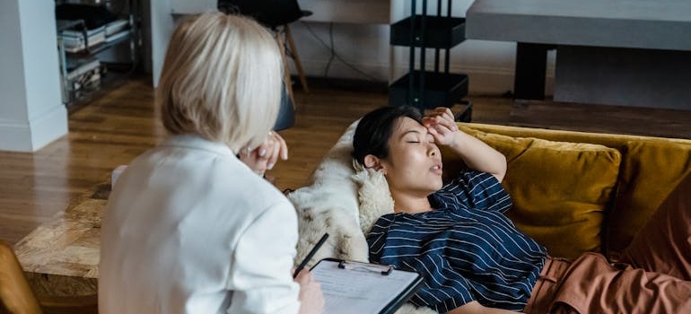 Woman lying on the couch while practicing calming techniques with her therapist.