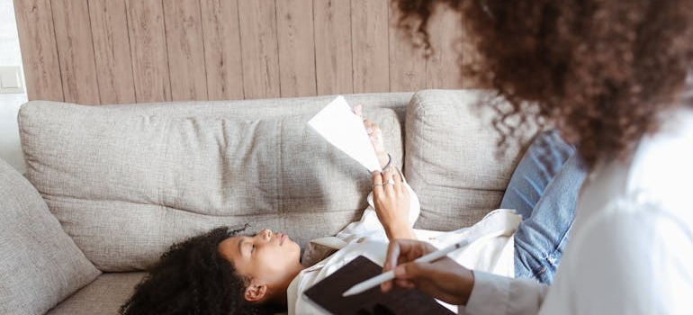 Woman reading a paper while in therapy.