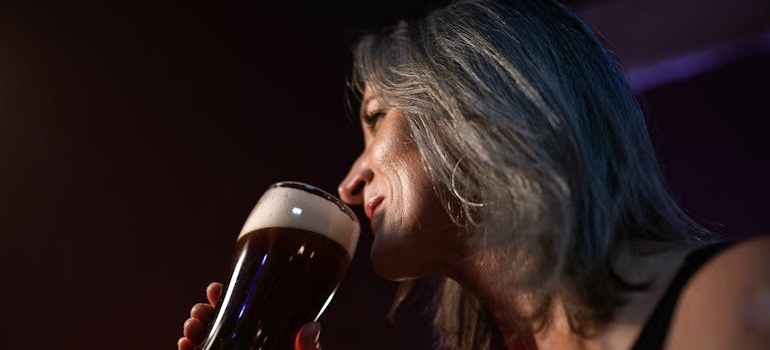 Woman drinking a glass of beer.