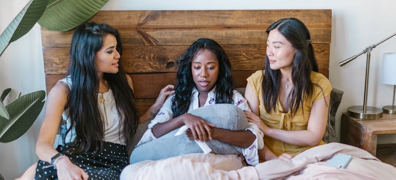 Two women comforting their crying friend.