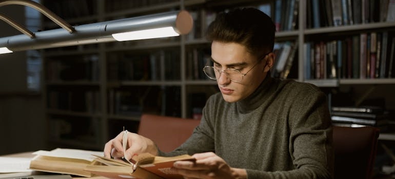 Man studying how addiction changes the brain in a library.