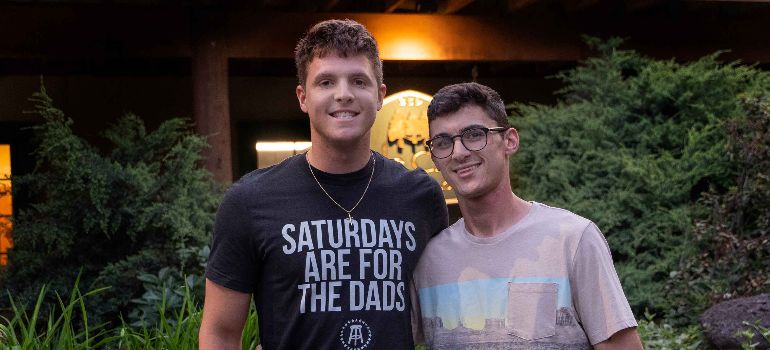 two alumni smiling