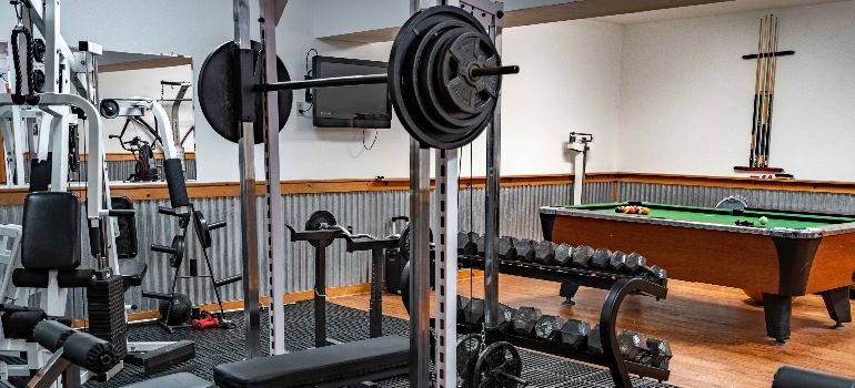 a side look at the gym equipment and billiard table at the little creek facility
