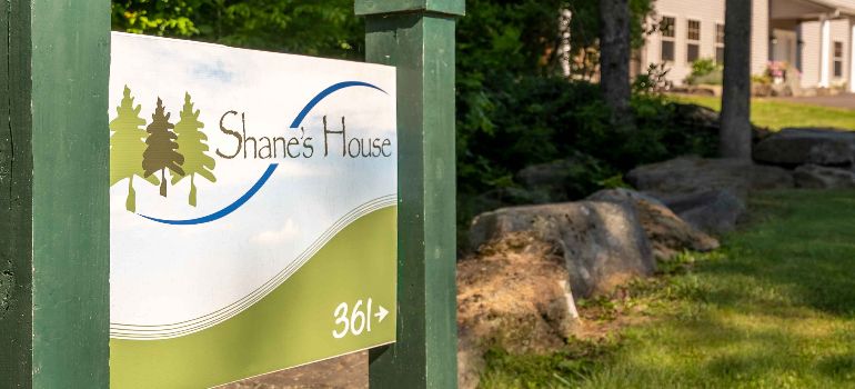 a sign Shane's House pointing at the location