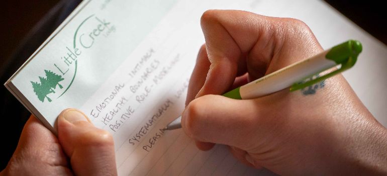A therapist at residential treatment center Pennsylvania writing a therapy plan in notebook