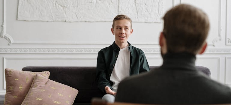Young man in therapy talking about fentanyl abuse signs.