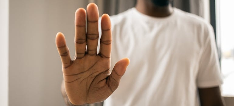 Man refusing a drink while trying to become sober curious.