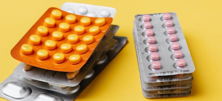 Blisters of different types of pills on top of each other.