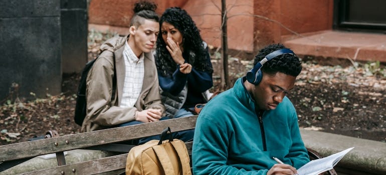 People whispering behind a man's back.