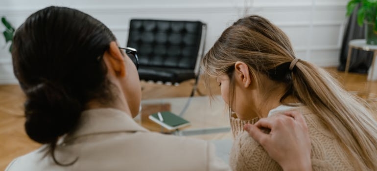 Therapist comforting an upset patient.