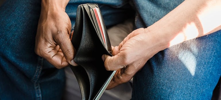 Man opening an empty wallet.