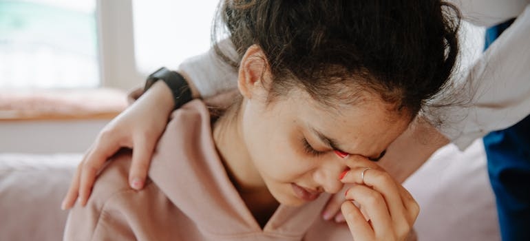 Woman comforting her stressed friend.