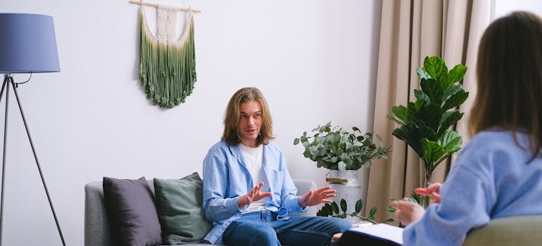 Young man in therapy talking about fentanyl abuse signs.