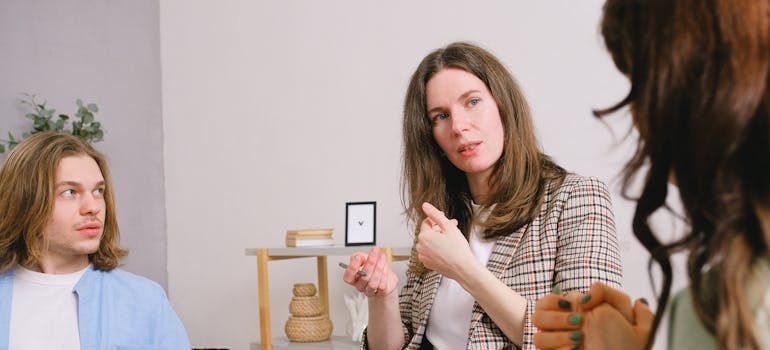 Therapist explaining the harm of drug addiction stereotypes to clients.