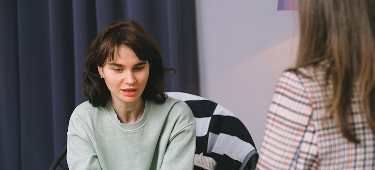 Woman in therapy talking with her therapist about how boredom triggers relapse.