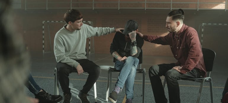 Peers supporting a man talking about his struggles with drug addiction stereotypes.