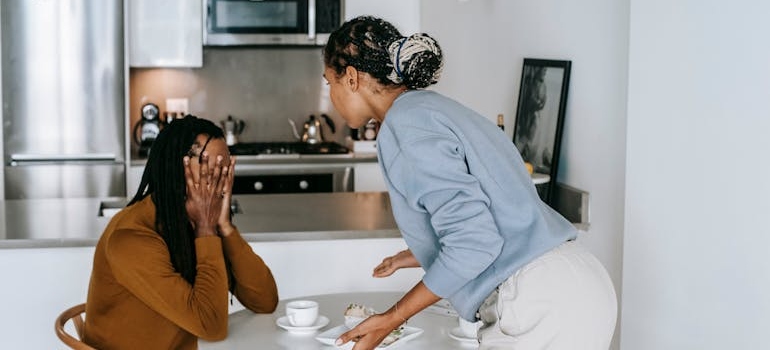 Man covering his face while his partner yells at him.