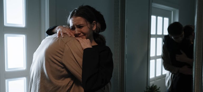 Couple crying and hugging after talking about new drug trends in Pennsylvania.