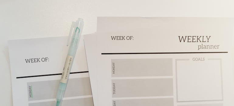 Weekly planner papers and a pen.