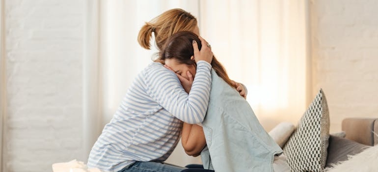 Woman hugging her crying friend.