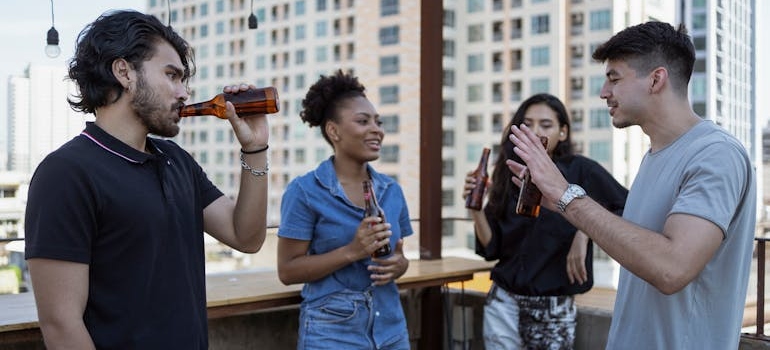 Group of friends drinking beer while partaking in day drinking culture.