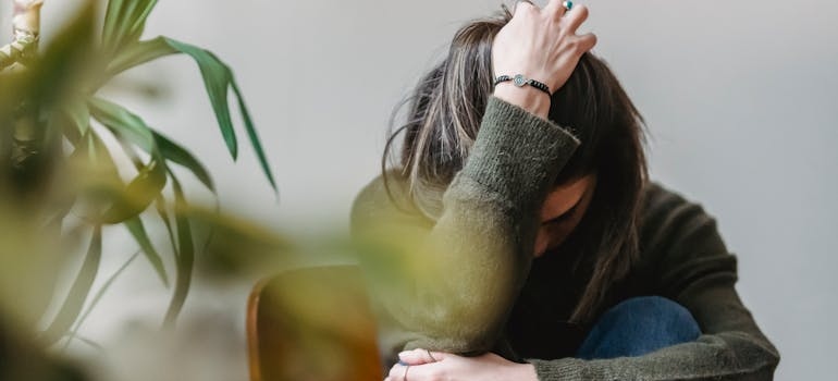 Depressed woman running her hand through her hair.