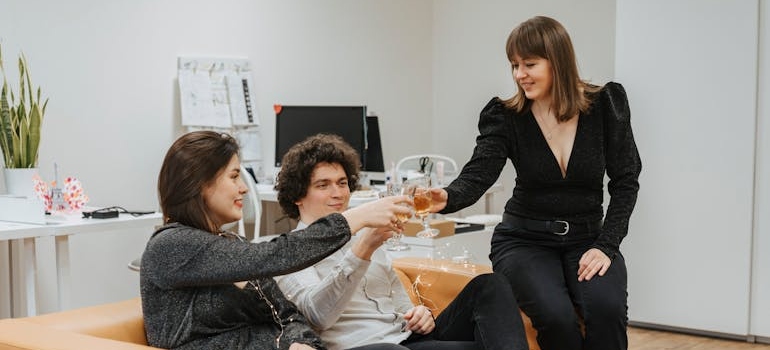 Colleagues toasting with alcoholic drinks.
