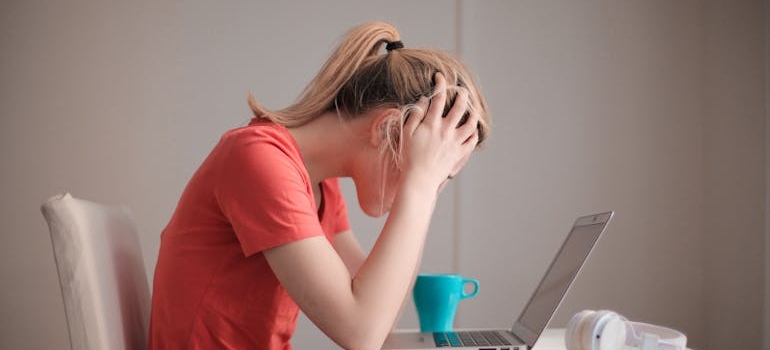 Worried woman looking at her laptop while thinking about Adderall abuse among college students.