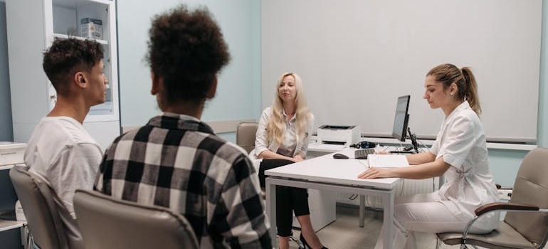 Couple talking with a doctor and a nurse.