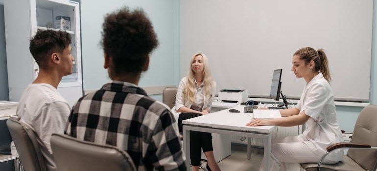 Couple talking with a nurse and a doctor about new drug trends in Pennsylvania.