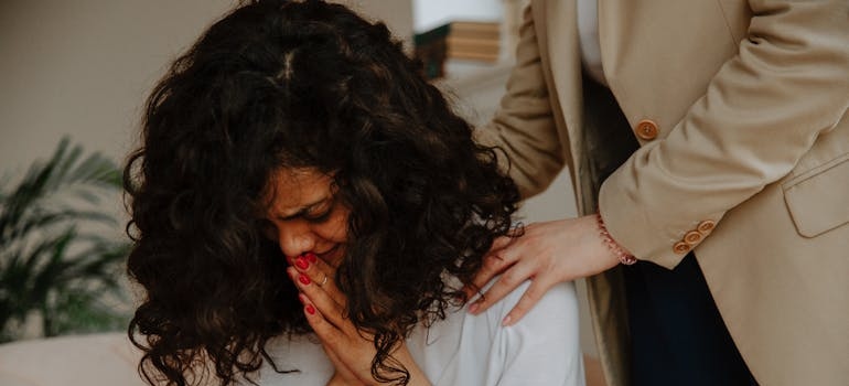 Woman comforting a girl while talking about a suicide attempt.