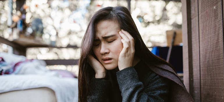 Woman having a headache after microdosing psychedelics.