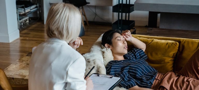 Client lying on the couch and talking about the struggles with new drug trends in Pennsylvania to her therapist.