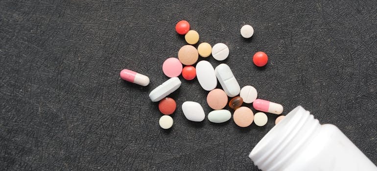 Pills spilling out of a bottle.
