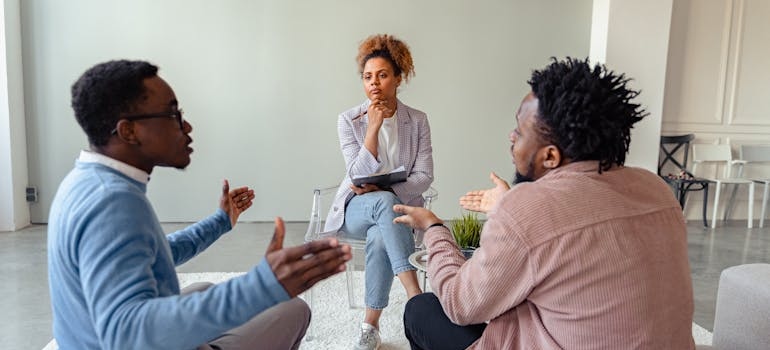 People in group therapy talking about relapse triggers.