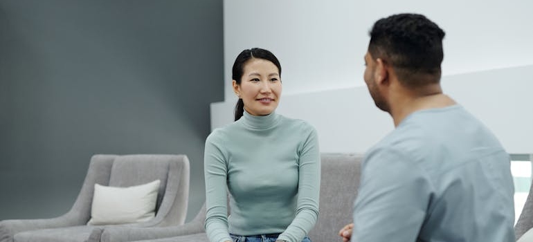 Woman talking about how to pay for rehab with a nurse.