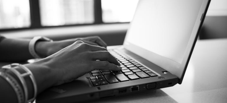 Person typing on their laptop.