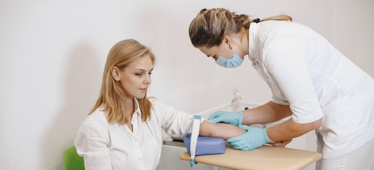 Nurse taking a patient's blood showing how nurses and doctors provide medical detox support.