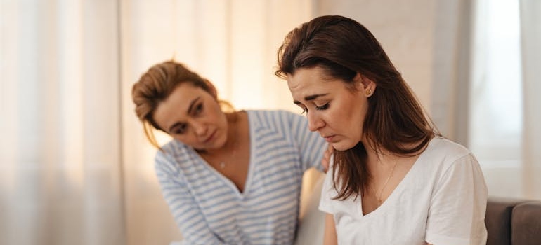 Woman comforting her upset friend.