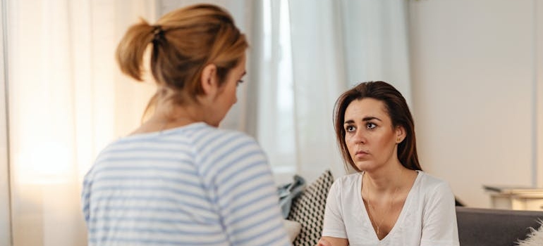 Two women having an emotional, serious conversation.