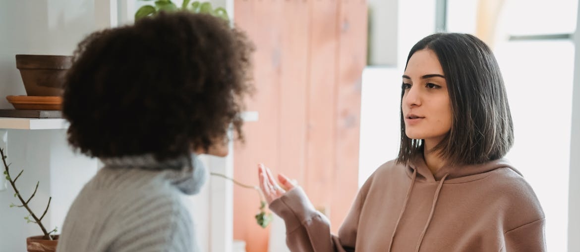 Two women having a serious conversation.